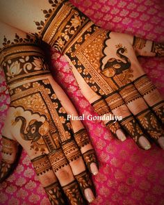 the hands and feet of a woman with henna tattoos