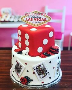 a red and white cake sitting on top of a wooden table