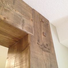 the corner of a wooden shelf is made out of planks and has been painted white