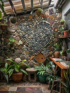 a heart shaped rock wall with potted plants in the corner and on the floor