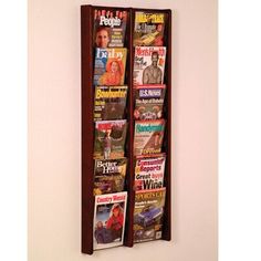 a wall mounted magazine rack with magazines on it