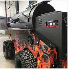 a large black grill with flames on it