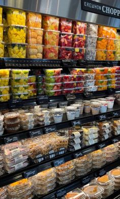 a display in a grocery store filled with lots of fruits and vegtables