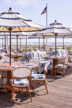 an outdoor dining area with tables and umbrellas