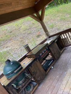 an outdoor grill on the back deck of a house