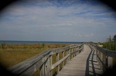 a wooden walkway leading to the beach