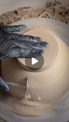 a person's hands on a pottery wheel