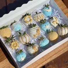 a box filled with lots of different types of cakes and pastries on top of a table