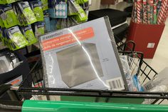 a shopping cart in a store with some items on the shelf and other items for sale