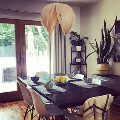 a dining room table with chairs and plates on it