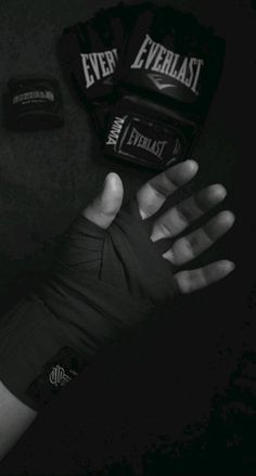 a person's hands with wrist wraps around them