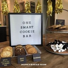 there is a sign that says one smart cookie bar next to some baked goods on the table