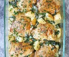 chicken and spinach casserole in a glass dish on a gray table top