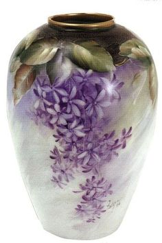 a vase with purple flowers painted on it