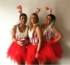 three women dressed up in red and white outfits posing for the camera with their hands on their hipss