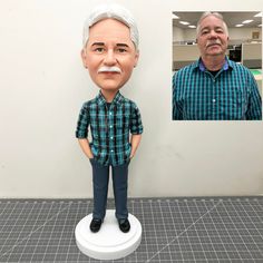 a man standing next to a fake head of an older man in a blue shirt