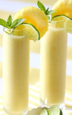 two tall glasses filled with cucumber and lemonade