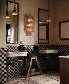 a bathroom with checkered walls and two sinks