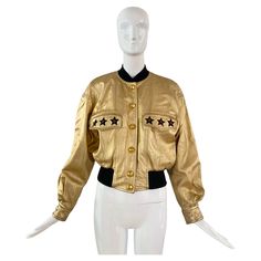 1990s Escada leather bomber jacket in gold leather with embroidered stars, gold snap buttons, and a stretchable waistband. Some fading to the gold on the leather and a hole was made in the inside lining of the jacket which has been patched up. Marked as a size 38. Measurements Shoulders: 20 in Bust: 34 in Waist: 26 in Sleeves: 24 in Length: 21 in Girl Money, Stars Gold, Embroidered Stars, Bill Blass, Flight Jacket, Gold Leather, Yves Saint Laurent, Bomber Jacket, Nordstrom