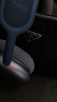 a close up of a black chair with a blue armrest and seat cushion on it