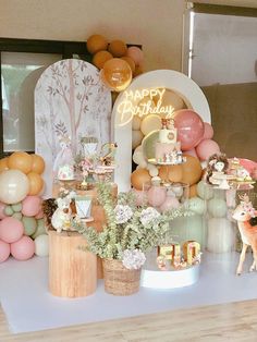 a birthday party with balloons, decorations and deer figurines