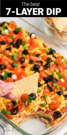 the best 7 - layer dip recipe is made with tortilla chips and black olives