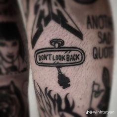 a close up of a person's leg with tattoos on it and the words don't look back