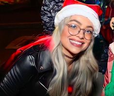 a woman wearing glasses and a santa hat