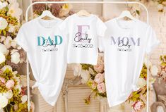 "Create unforgettable memories with our personalized family matching outfit set. Our collection includes comfortable and stylish adult white t-shirts and cute baby bodysuits, all designed to celebrate the bond within your family. Each item of clothing can be matched with the Your child's name and date of birth can be personalized, adding a special touch that captures the uniqueness of your little one. Crafted with care, our family matching outfits are made from high quality, soft fabrics that pr White Family Matching Sets With Letter Print, White Matching Set Tops, White Cotton Gift Sets, Customizable White Gift Sets, Customizable White Tops For Family Events, White Top For Mother's Day Family Events, Personalized White Family Matching Tops, White Cotton Matching Outfits Set, White Cotton Matching Outfit Sets