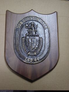 a wooden plaque with a coat of arms on it