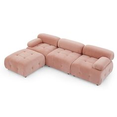 a pink sectional sofa sitting on top of a white floor