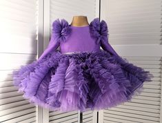 This beautiful dress is sure to please your baby. The dress has a very beautiful unusual fluffy skirt. The dress of a rich lavender color is sewn from a fabric with a shiny coating. The dress shimmers very beautifully and looks luxurious. On the back of the dress there is a long zipper and a beautiful bow. the dress is knee-length. The sleeve in the dress has a length of 3/4, but at your request it can be made long or removed completely. The dress is sewn to order within 7-10 days. If you have any questions, please write to me and I will do my best to make you satisfied with your purchase in my store. Booties can be sewn into the dress set(paid additionally) Booties size (outer sole length): 9.5 cm 0-3 months 10.5 cm 3-6 months 11.5 cm 6-9 months 12.5 cm 9-12 months Lavender Fitted Princess Dress For Dress-up, Purple Tulle Dress With Ruffles, Elegant Lavender Princess Dress For Dress-up, Fitted Lavender Tulle Princess Dress, Lavender Tulle Dress With Ruffles, Fitted Purple Tutu Dress For Spring, Lavender Princess Dress With Ruffles, Elegant Lavender Princess Dress For Pageants, Cute Lavender Party Dress