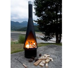 an outdoor fire pit with logs and wood