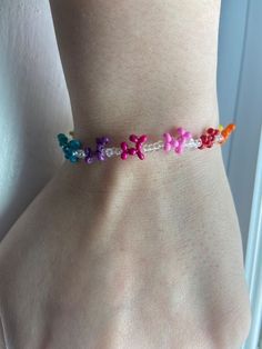 a woman wearing a bracelet with colorful beads