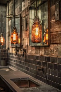 three mason jars are hanging from the wall above a sink in an industrial style kitchen