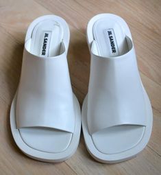 Jil Sander White Leather Slides Shoes with Kitten Heels Sz 7 Retail $750 | eBay Designer Slip-on Sandals With Sculpted Heel, Modern Sandals With Sculpted Heel And Almond Toe, Modern Almond Toe Sandals With Sculpted Heel, Designer Slip-on Heels With Sculpted Heel, Modern Sandals With Almond Toe And Reinforced Heel, Modern Calf Leather Sandals With Almond Toe, Modern Slip-on Calf Leather Heels, Modern Calf Leather Slip-on Heels, Modern Slip-on Heels In Calf Leather