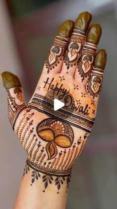 a woman's hand with henna on it and the words happy new year written in