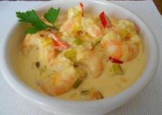 a white bowl filled with shrimp and vegetables