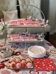 a table topped with lots of cakes and cookies