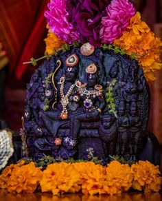 an intricately decorated statue with flowers on it