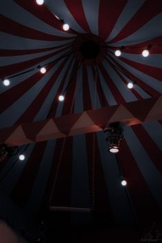 a large tent with lights hanging from it's ceiling