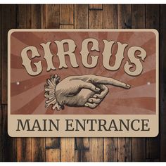 a sign that says greus main entrance with a hand pointing at the viewer