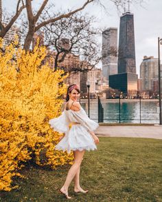 a woman standing in front of yellow flowers with the words best spring photo locations in chicago