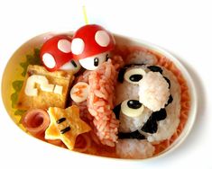 a plate with some food on it and two stuffed animals in the bowl next to each other