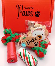 an orange box with red and green yarn, teddy bears and candy canes