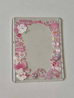 a mirror that has some buttons on the side of it with animals and hearts around it