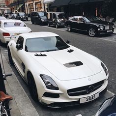 a white sports car parked on the side of a street