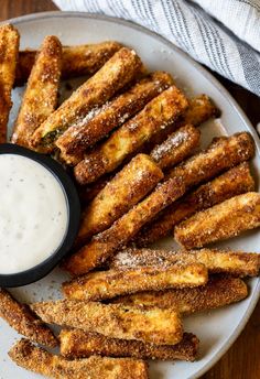 fried french fries on a plate with dipping sauce