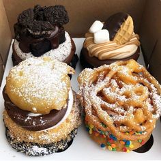 a box filled with assorted flavored donuts and pastries on top of each other