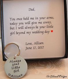 a keychain with a poem written on it in front of a framed photo